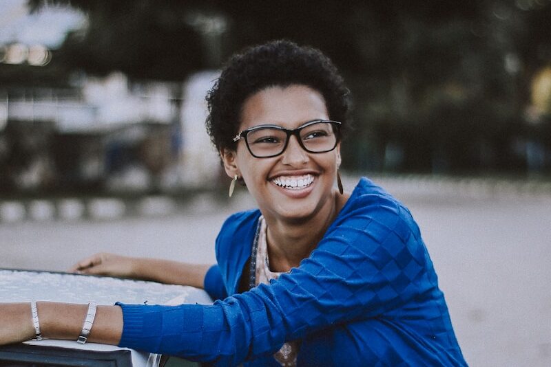 Photo by Vinicius Wiesehofer woman wearing gray denim jacket and black scarf