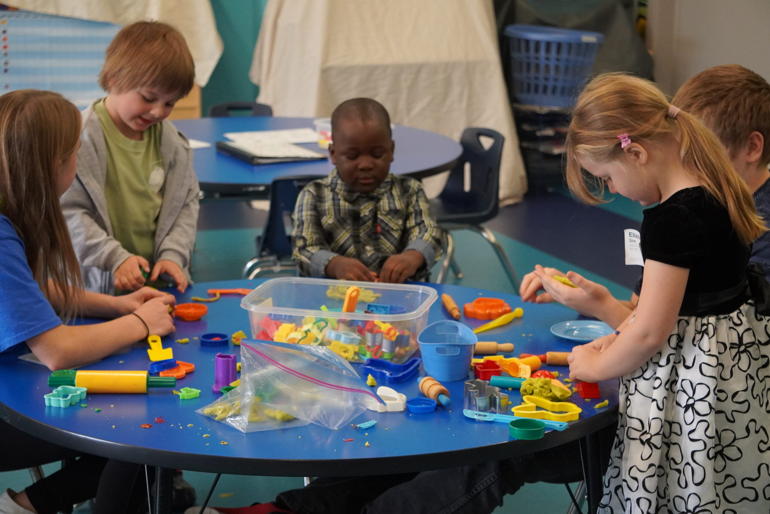 boy sitting on bench while holding a book